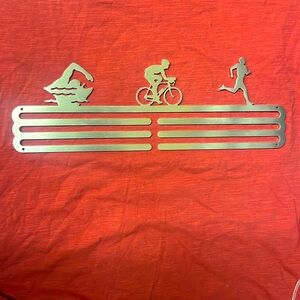 Triathlete- swim, bike run 
Metal hanger display for wall.